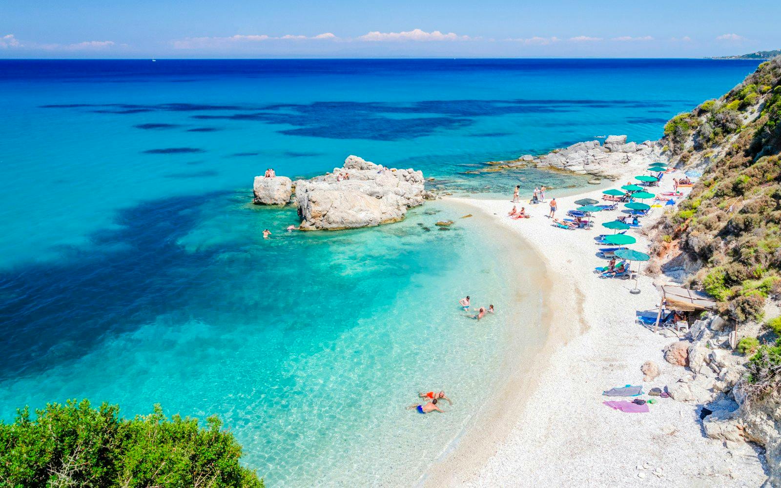 Xigia Beach with swimmers in sulphur waters, Zakynthos, Greece.