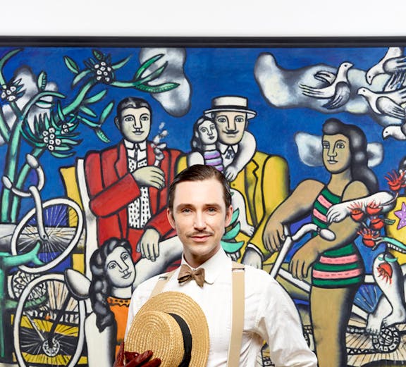Man posing in front of famous artwork at Centre Pompidou.