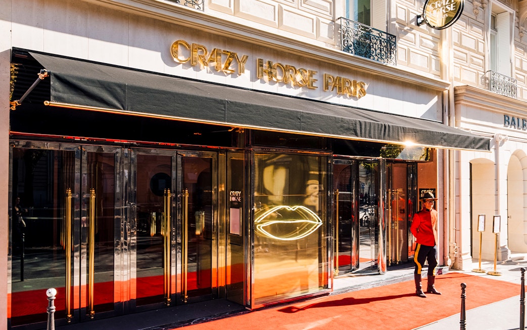 Crazy Horse Paris entrance with red carpet and doorman.