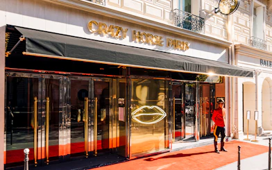 Crazy Horse Paris entrance with red carpet and doorman.