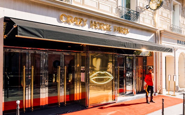 Crazy Horse Paris entrance with red carpet and doorman.