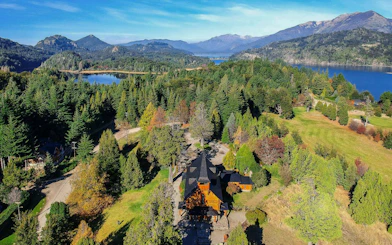 Aerial view of Llao Llao area with lakes, forests, and mountains in Bariloche.