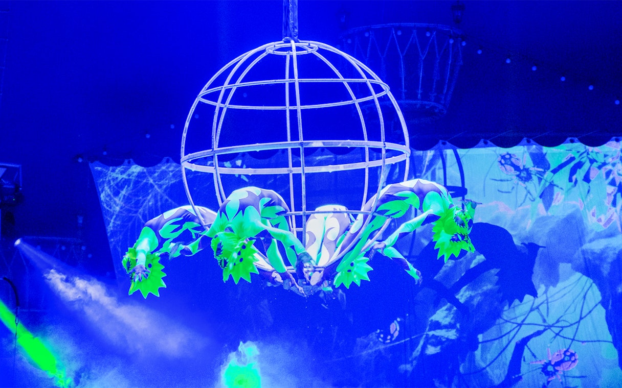 Acrobats performing in a spherical cage at Aqua Circus Phuket.