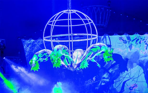 Acrobats performing in a spherical cage at Aqua Circus Phuket.