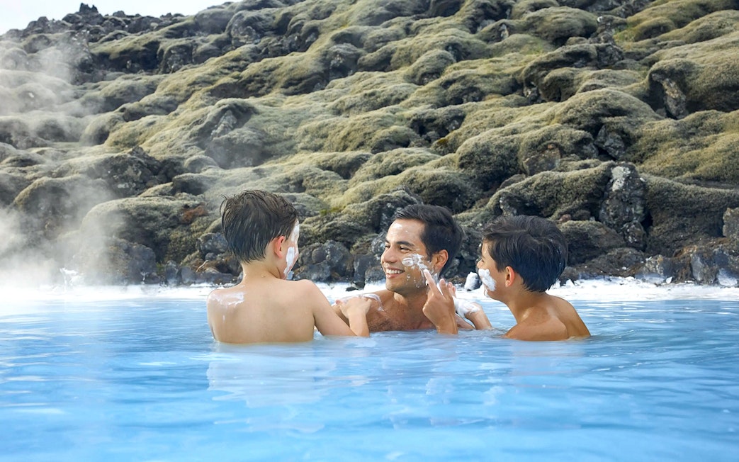 Family enjoying geothermal waters at Blue Lagoon, Iceland.