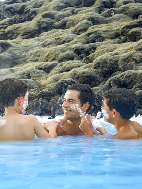 Family enjoying geothermal waters at Blue Lagoon, Iceland.