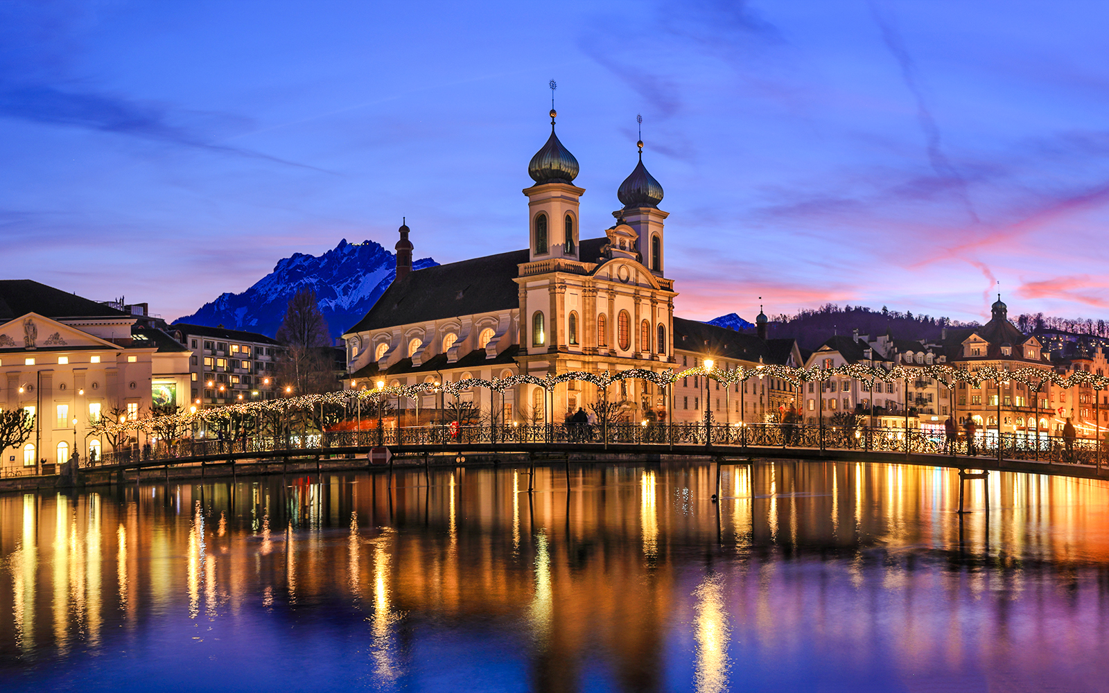 Lucerne's Jesuit Church and Reuss River at sunset during Christmas, Switzerland.