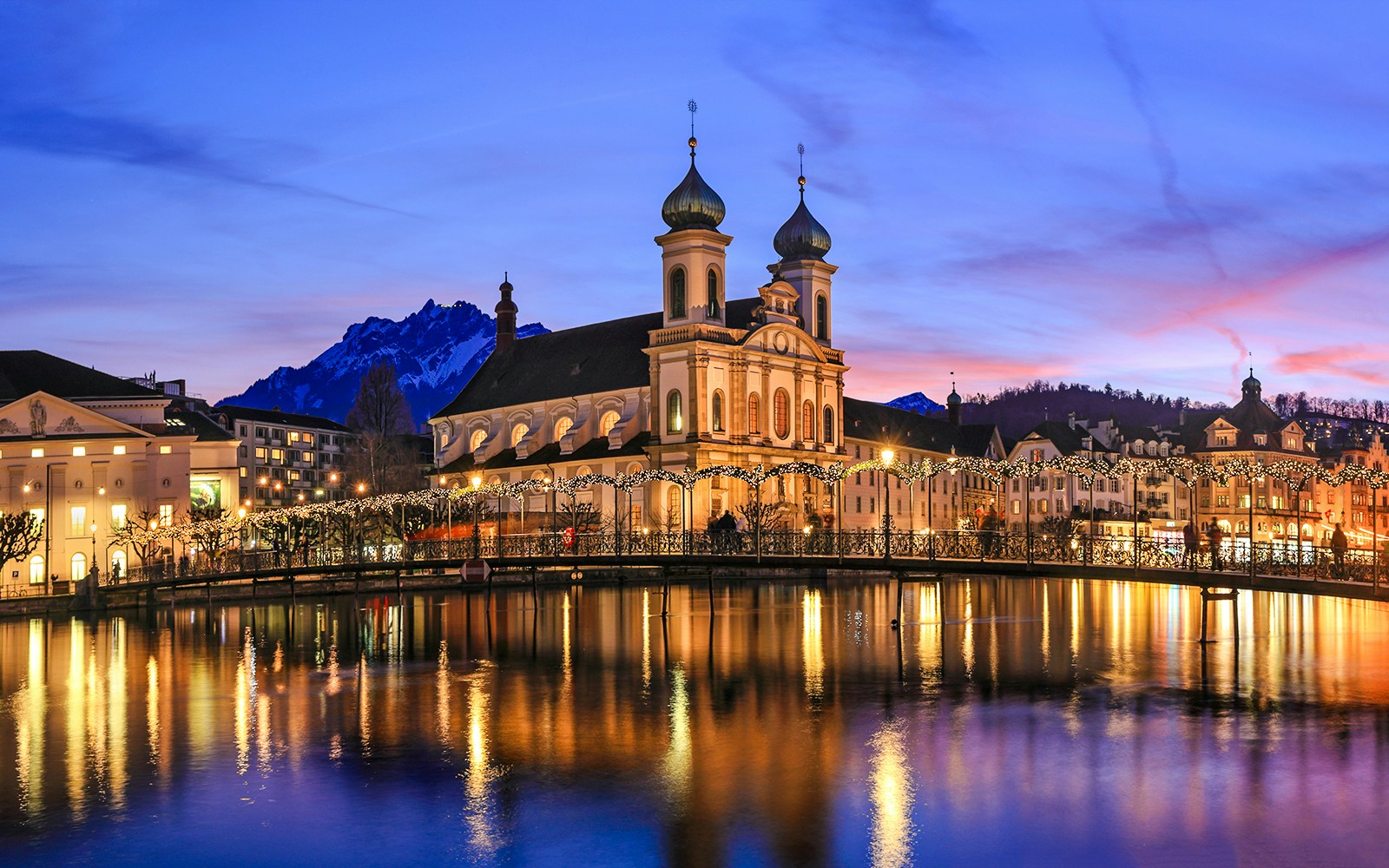 Lucerne's Jesuit Church and Reuss River at sunset during Christmas, Switzerland.