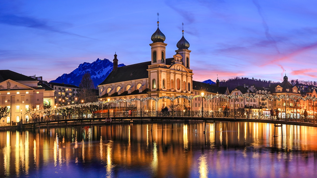 Lucerne's Jesuit Church and Reuss River at sunset during Christmas, Switzerland.