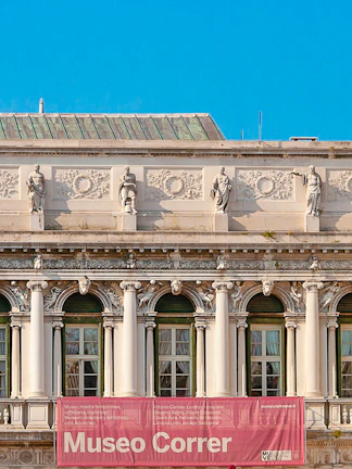 Correr Museum facade with statues and columns in Venice, Italy.