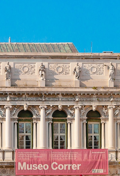 Correr Museum facade with statues and columns in Venice, Italy.
