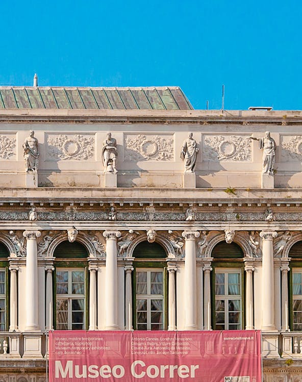 Correr Museum facade with statues and columns in Venice, Italy.