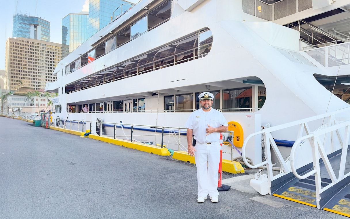 Cruise captain greeting guests at the dock in Oahu, Hawaii.