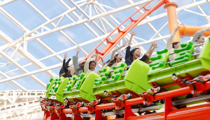 Roller coaster at American Dream Nickelodeon Universe in New Jersey with vibrant themed surroundings.