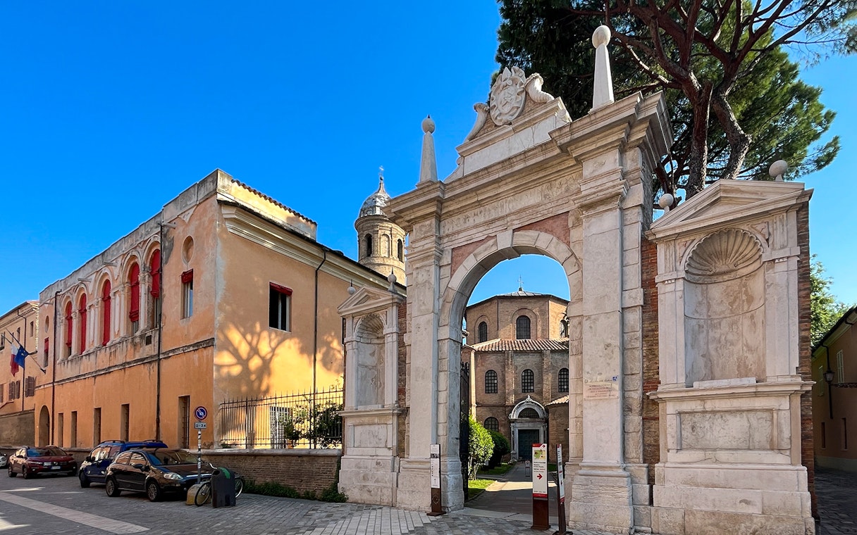 Entrance to Basilica di San Vitale, Ravenna, with historic architecture and mosaic tiles.