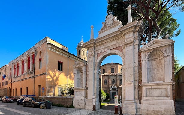 Entrance to Basilica di San Vitale, Ravenna, with historic architecture and mosaic tiles.