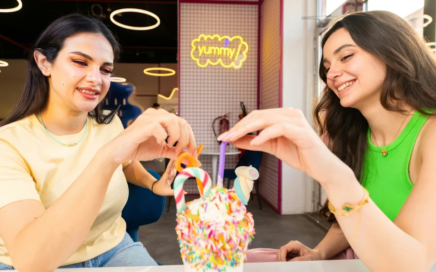 Visitors enjoying colorful candy treats at Museum of Candy, Dubai.