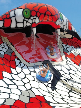 Visitors sliding down the snake-themed water slide at Aqualand El Arenal, Mallorca, Spain.