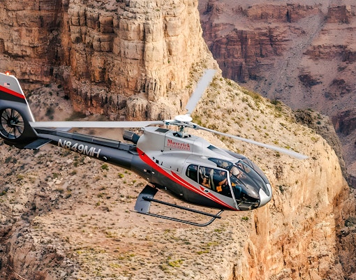 Maverick Helicopters Airbus EC130 flying over Grand Canyon with Las Vegas Strip views.