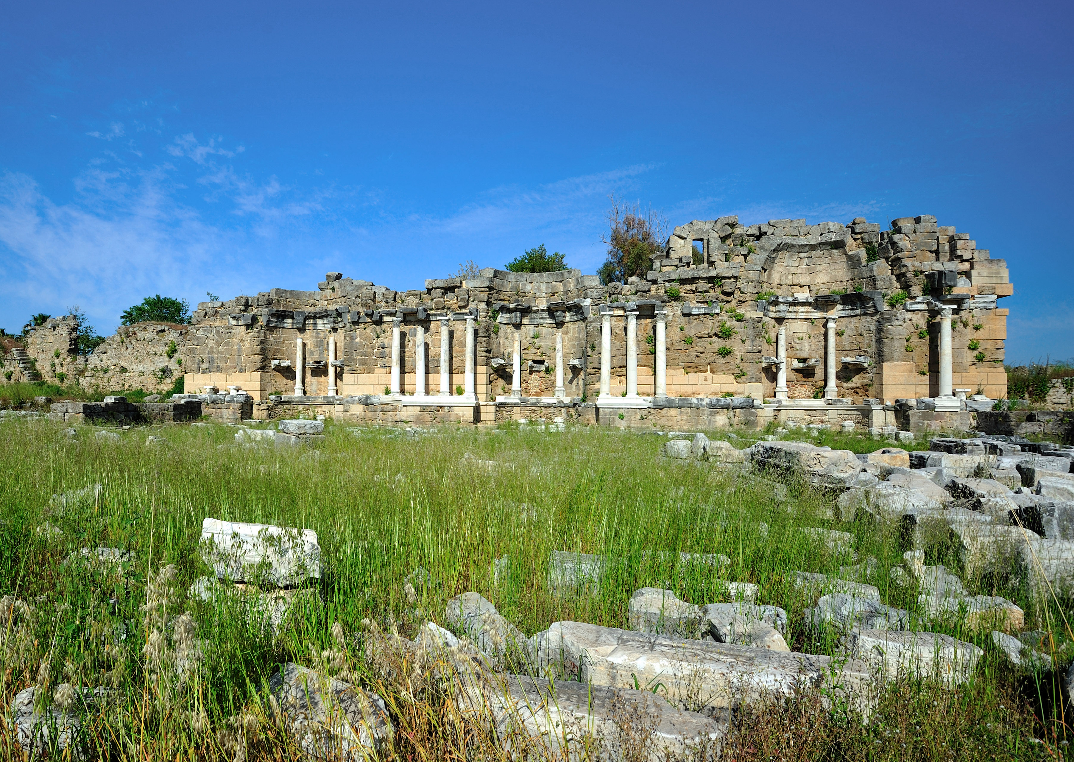 Klepsydra Fountain ruins in Ancient Agora, Athens, Greece, with stone columns and historical architecture.