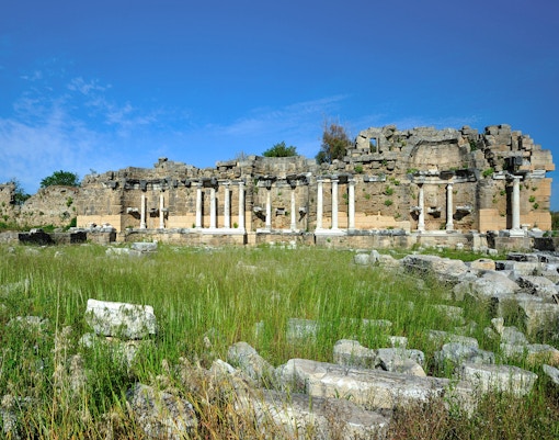 Klepsydra Fountain ruins in Ancient Agora, Athens, Greece, with stone columns and historical architecture.