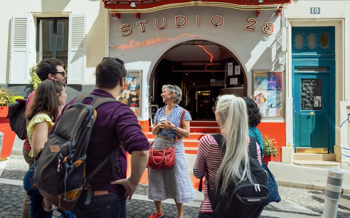 Tour group outside Studio 28 in Montmartre during Sacré Coeur walking tour.