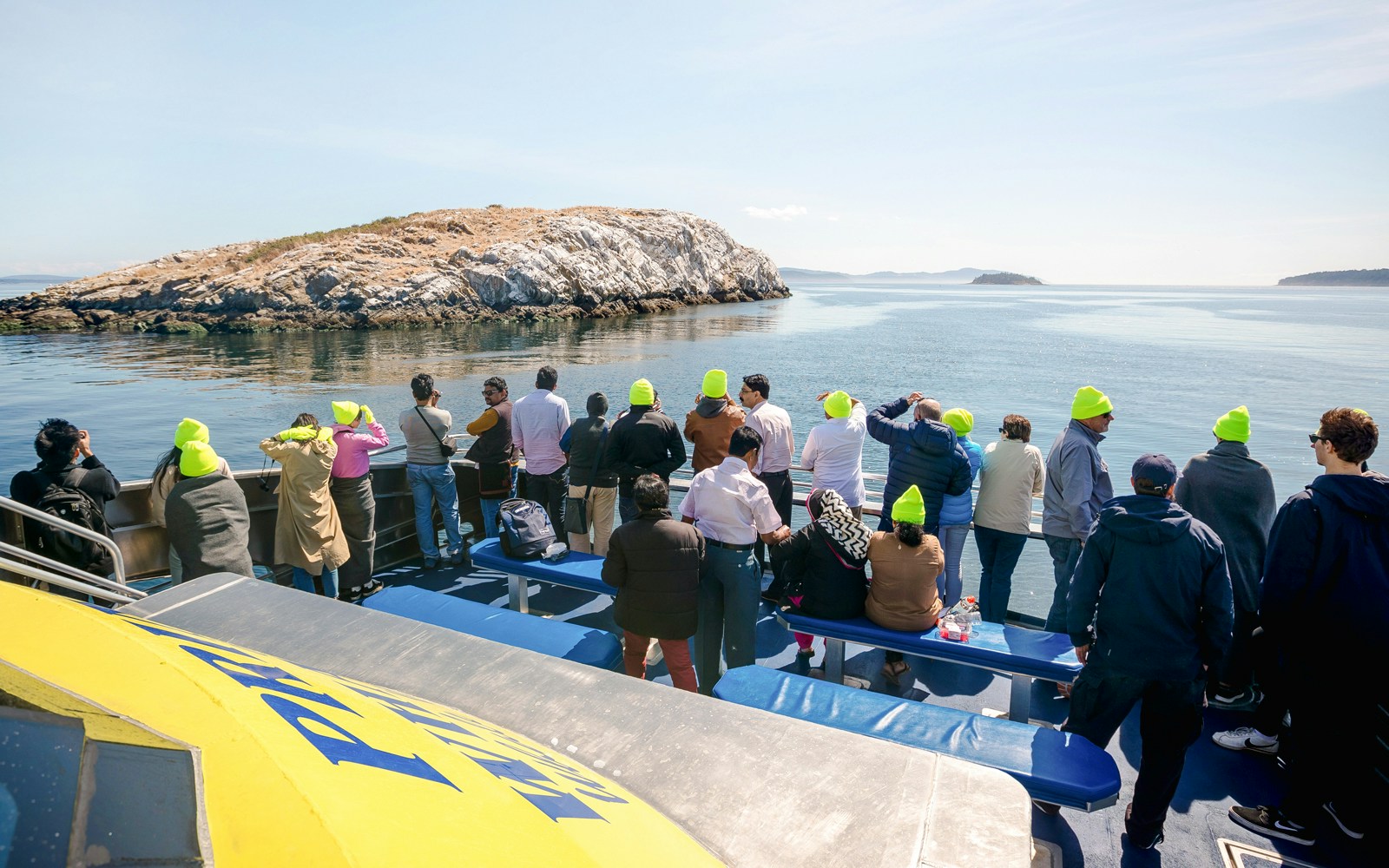 Group on a whale watching tour with Prince of Whales in Vancouver, viewing ocean and islands.
