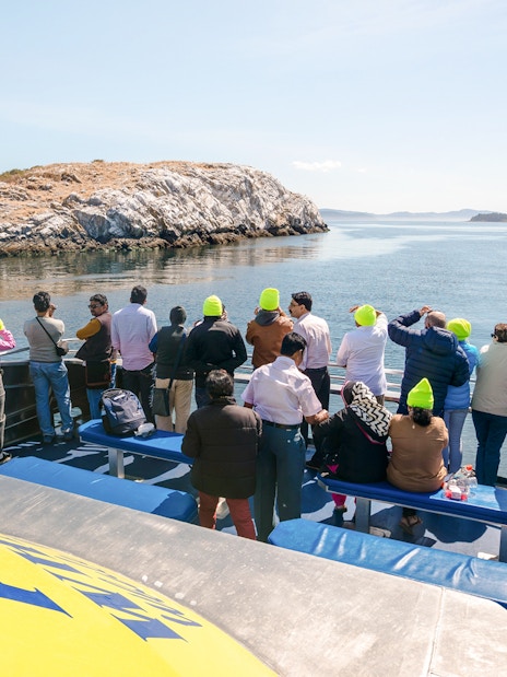 Group on a whale watching tour with Prince of Whales in Vancouver, viewing ocean and islands.