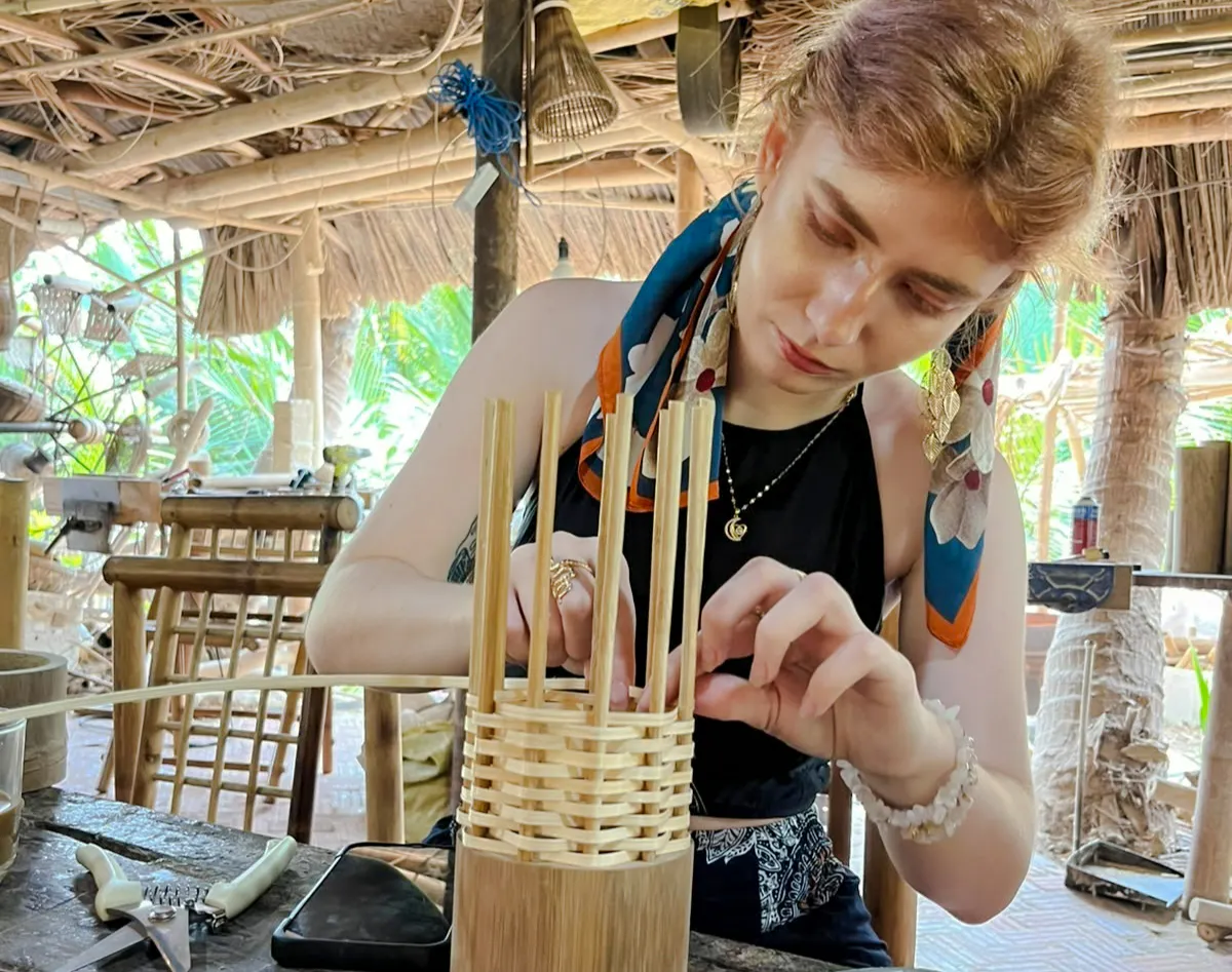 Crafting bamboo basket in Hoi An workshop, showcasing local Vietnamese culture and sustainability.