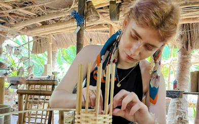Crafting bamboo basket in Hoi An workshop, showcasing local Vietnamese culture and sustainability.