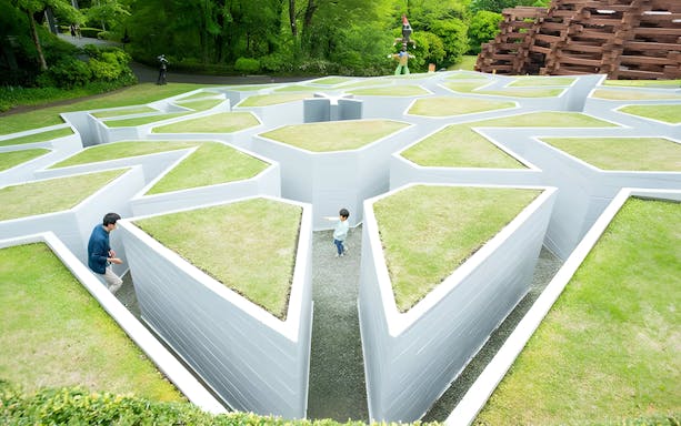 Visitors exploring a geometric maze at The Hakone Open-Air Museum, Japan.