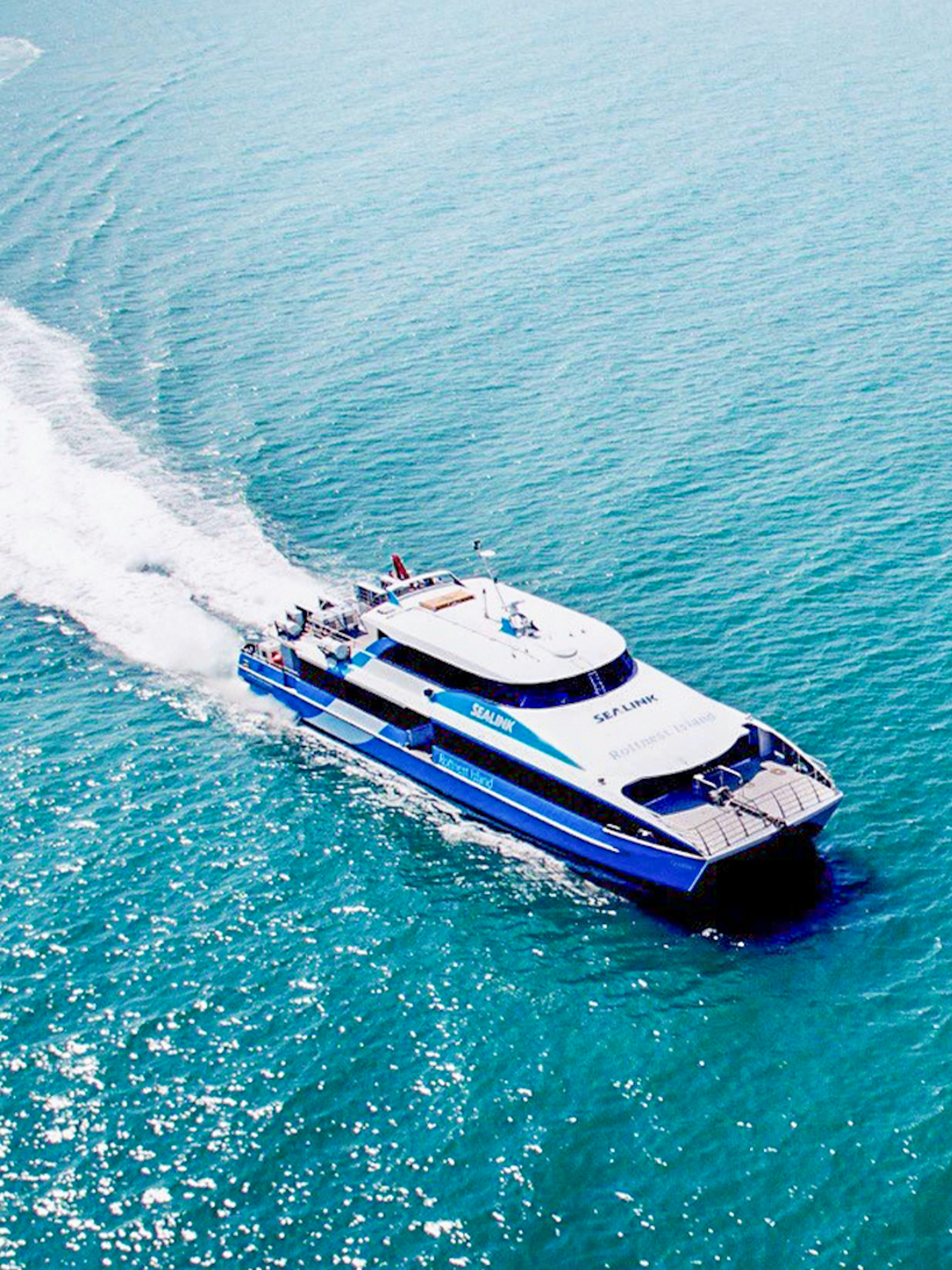 Ferry departing Rottnest Island towards Perth or Fremantle across the ocean.