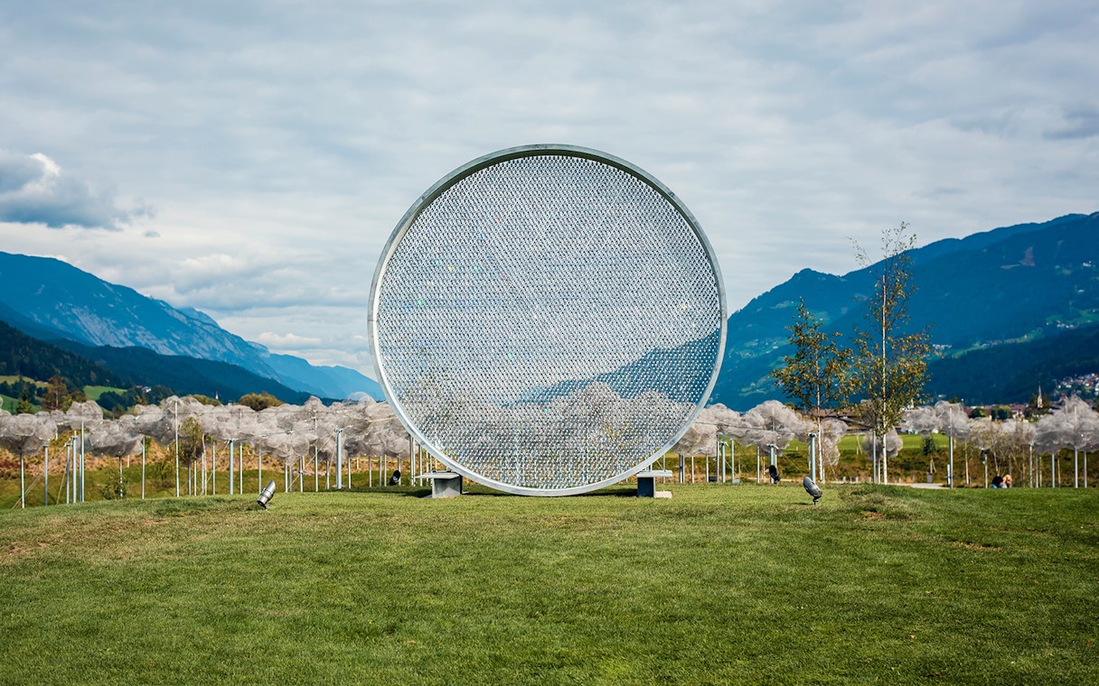 Swarovski Crystal Worlds outdoor art installation with mountain backdrop.