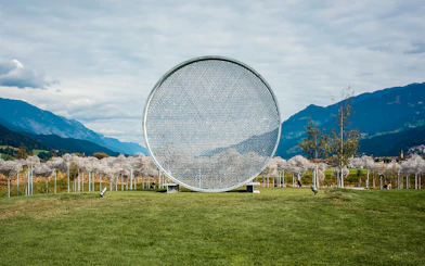 Swarovski Crystal Worlds outdoor art installation with mountain backdrop.