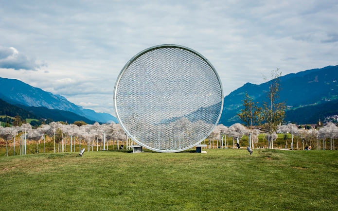 Swarovski Crystal Worlds outdoor art installation with mountain backdrop.