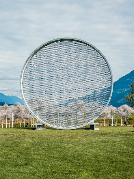 Swarovski Crystal Worlds outdoor art installation with mountain backdrop.