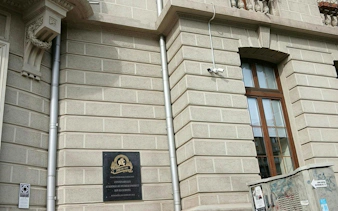 Plaque on historic building wall in Bucharest, part of the Mysterious Bucharest city exploration game.