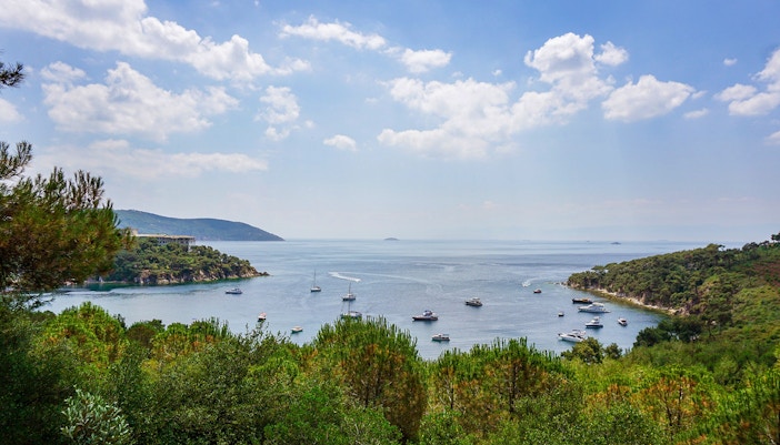 Princes' Islands ferry with passengers enjoying buffet lunch, Istanbul skyline in background.