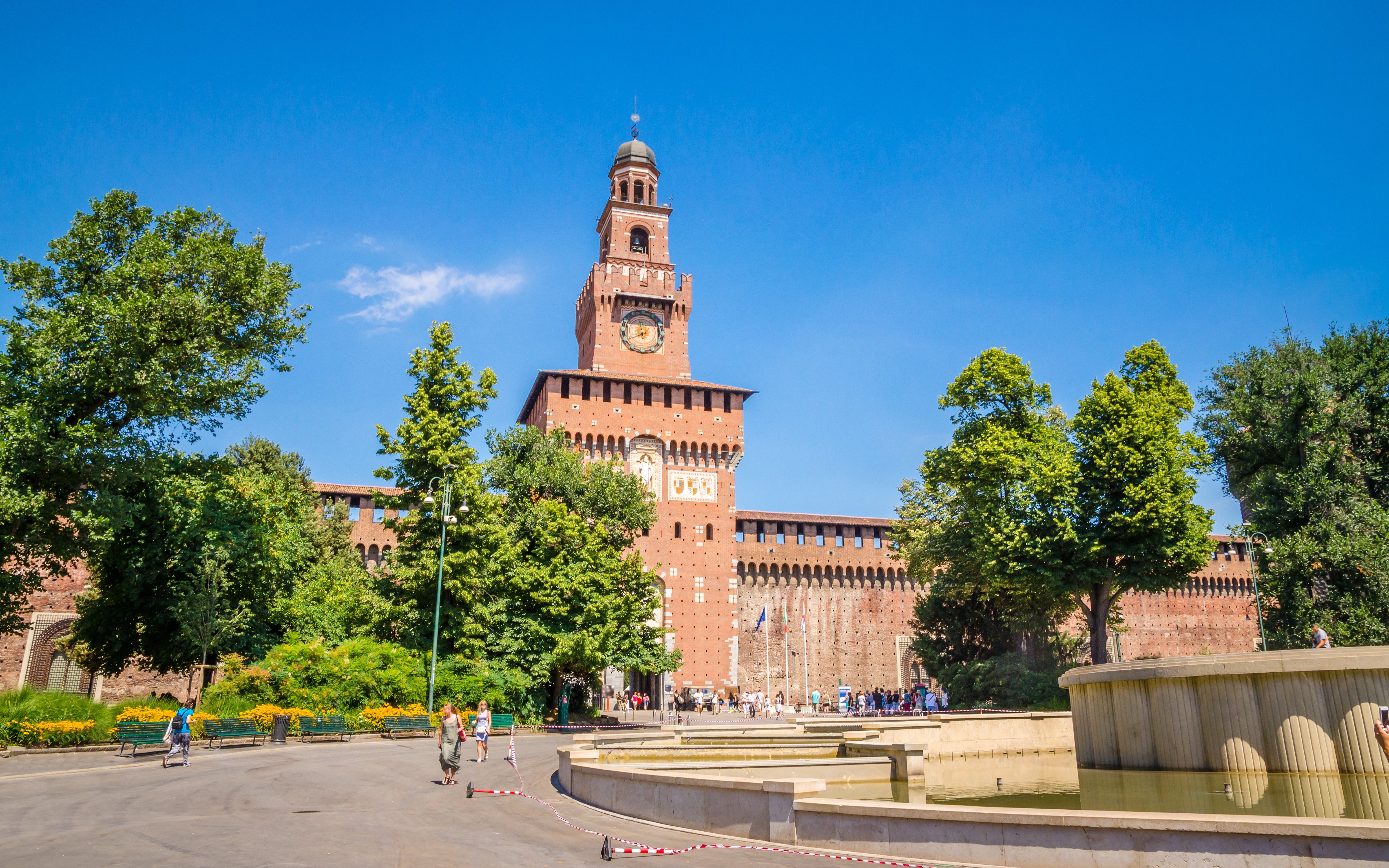 Sforza Castle in Milan with central tower and surrounding gardens.