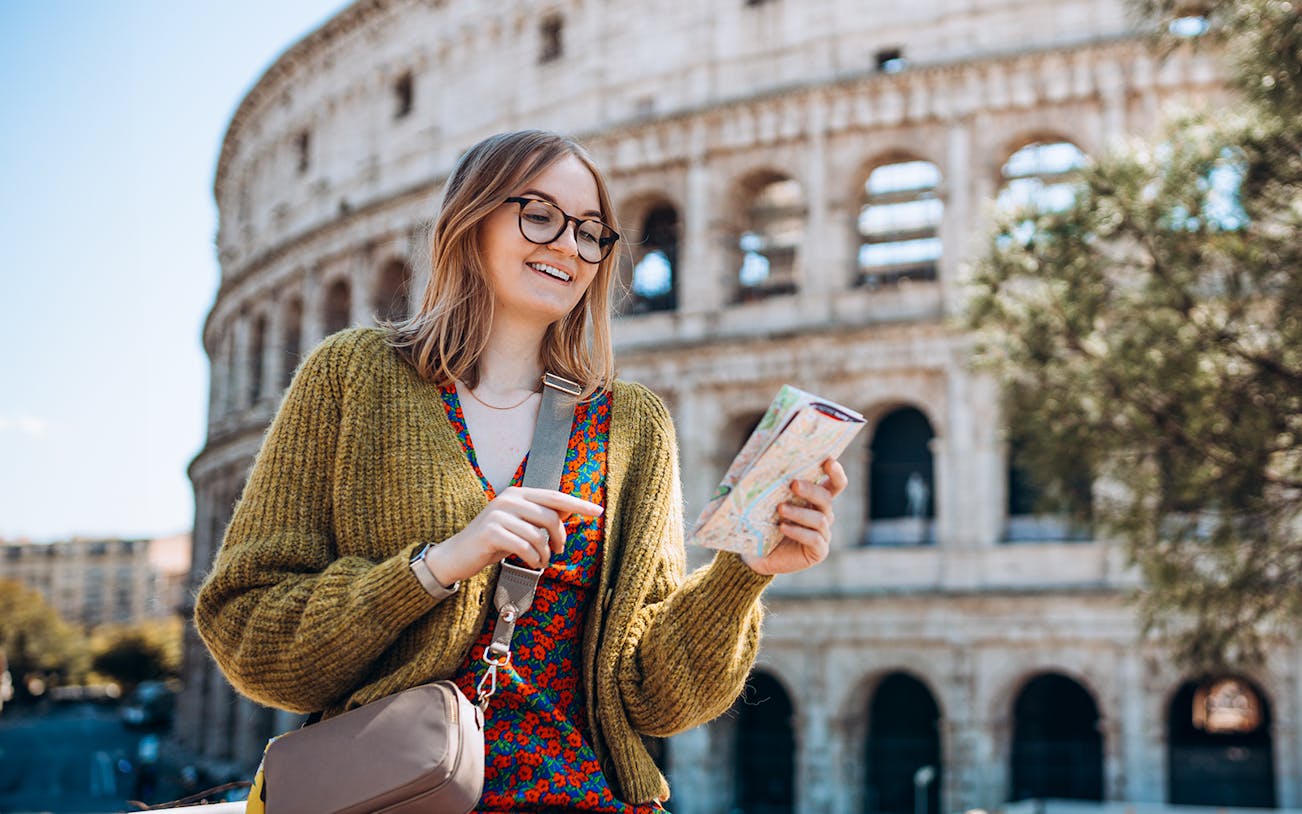 Tour guide explaining history at the Colosseum, Rome.