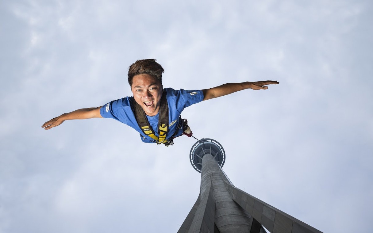 Bungee jumper descending from Skypark Macau Tower.