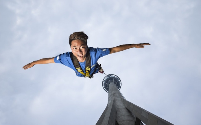 Bungee jumper descending from Skypark Macau Tower.