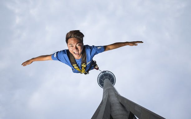Bungee jumper descending from Skypark Macau Tower.