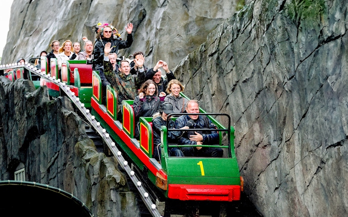 Visitors enjoying a roller coaster ride at Tivoli Gardens, Copenhagen.