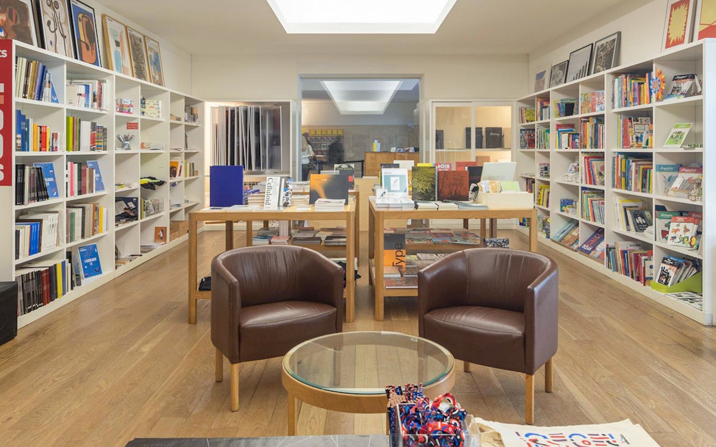 Serralves Foundation bookstore with shelves of books and seating area.