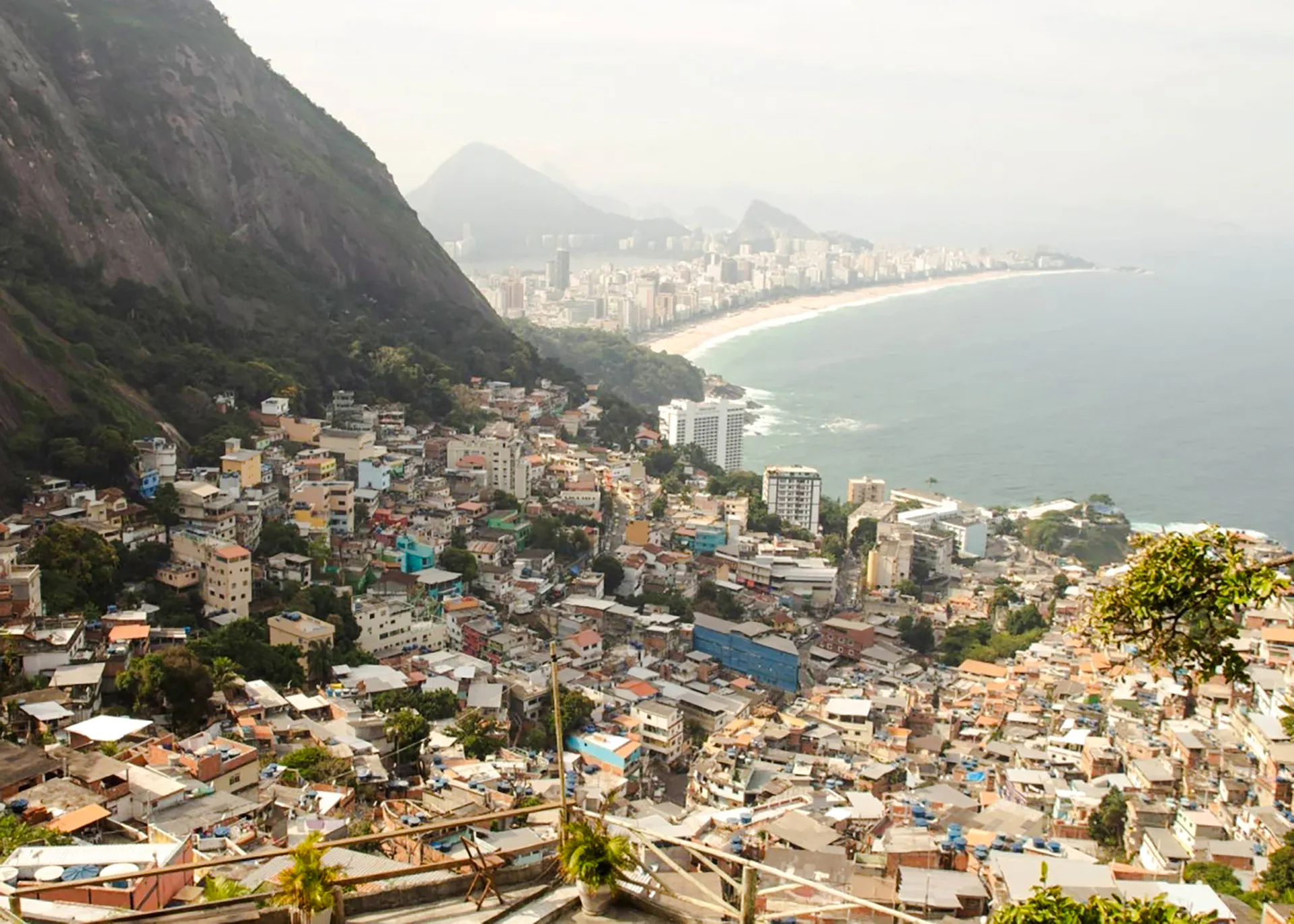 Aerial view of Vidigal favela with Rio de Janeiro coastline in the background.