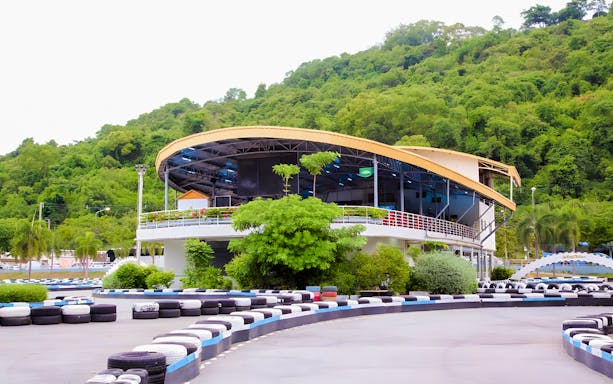 Outdoor karting track at Bali Hai Pier Pattaya with lush green hills in the background.