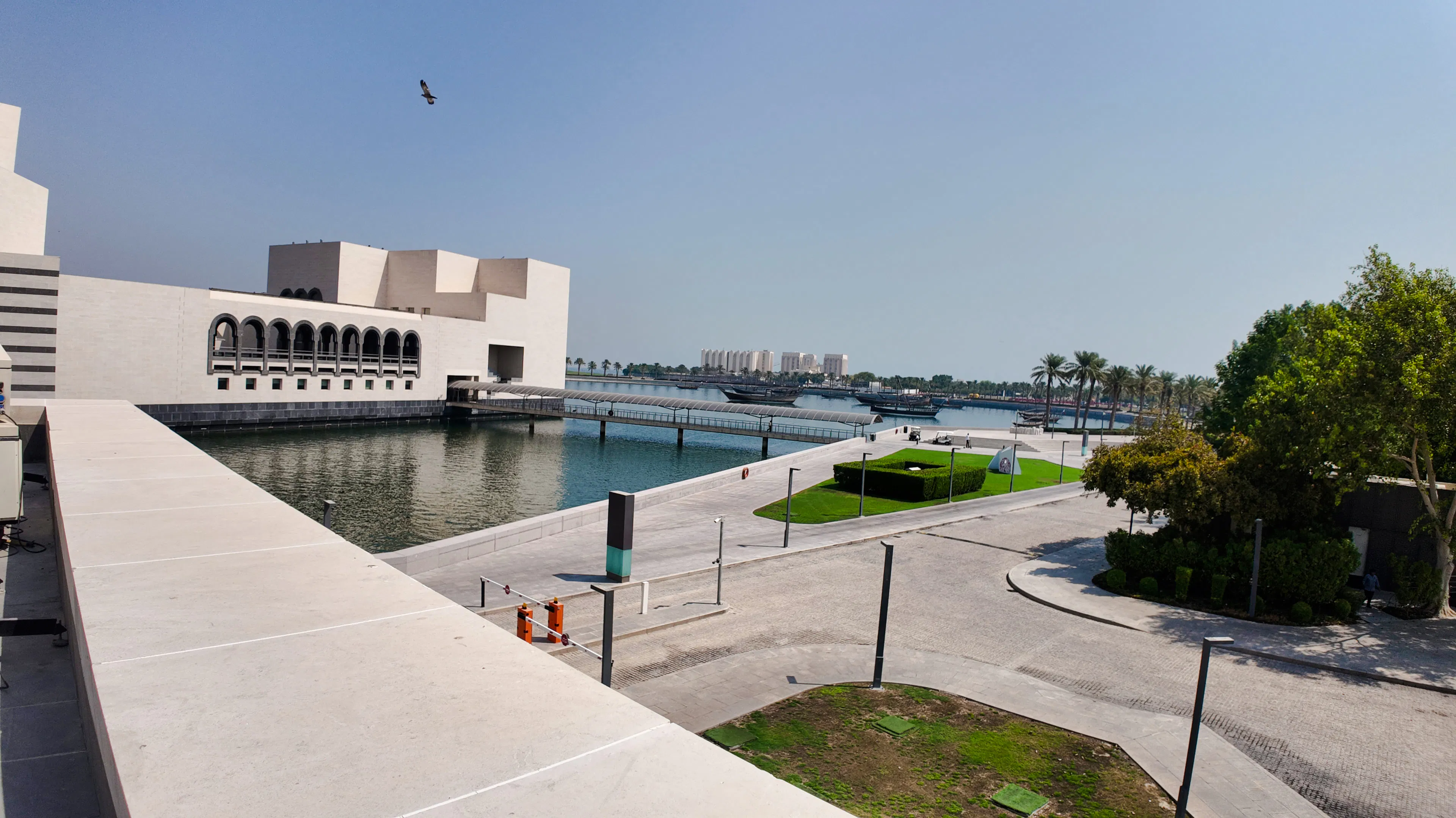 Museum of Islamic Art in Doha with waterfront view and palm trees.