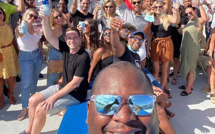 Group enjoying a party on a yacht in Washington, DC with drinks and city views.