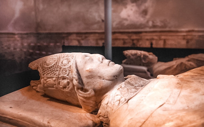 Stone effigy inside the Cathedral of Toledo during a guided tour.